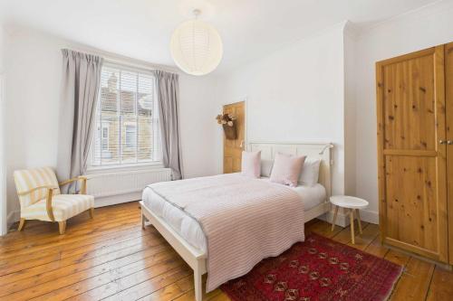 a bedroom with a bed and a chair and a window at Host & Stay - Salty Place in Saltburn-by-the-Sea