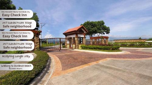 a building with signs in front of a driveway at Beach Resorts walking distance to the Town House in Davao City