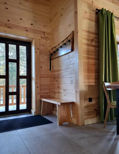 a room with a wooden wall with a bench and a window at GomuL in Vorokhta