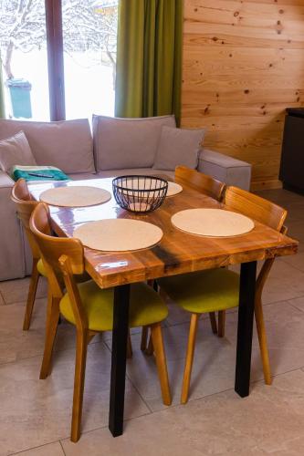 a wooden table and chairs in a living room at GomuL in Vorokhta