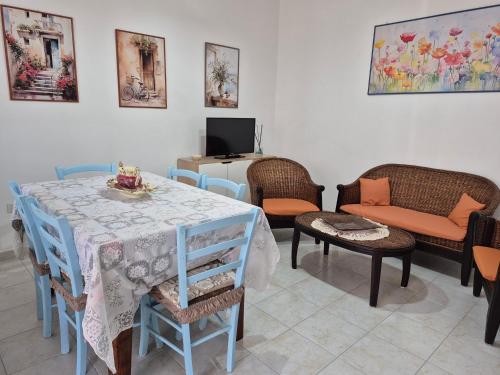 a room with a table and chairs and a tv at Nonno Gigi in Leuca