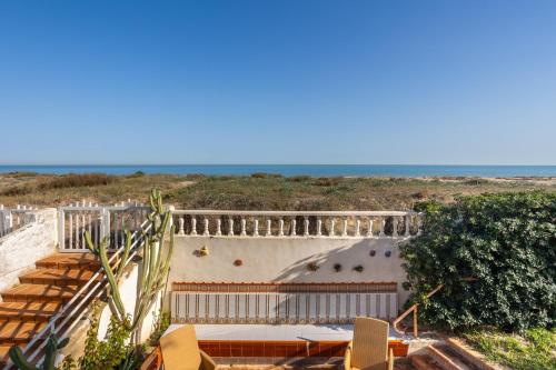 a staircase leading up to a building with the ocean in the background at Breathtaking Beachfront Villa in Xeraco in Xeraco