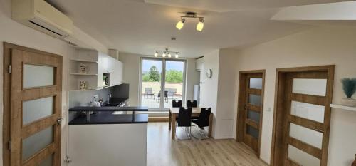 a kitchen and dining room with a table and chairs at Apartmán Tereza in Kutná Hora