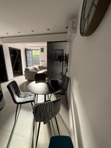 a living room with a table and chairs at Waves & Peaks Apartment in Zelenika