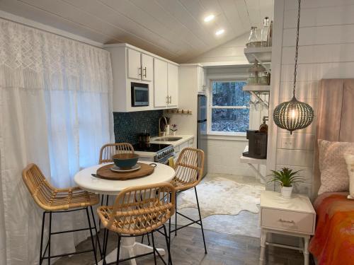 a kitchen with a table and chairs in a room at Cozy Couples Getaway in Morganton