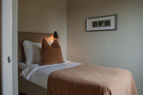 a bedroom with a bed with a lamp on it at Home Hotel Odin in Gothenburg
