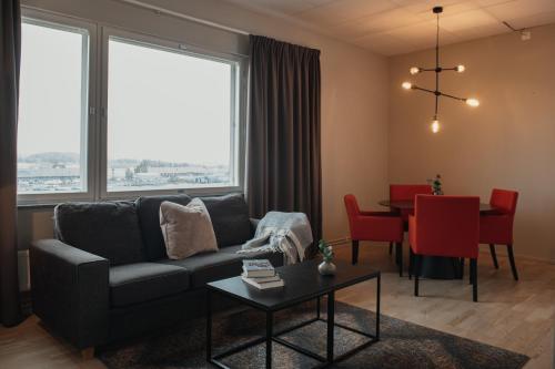 a living room with a couch and a table at Home Hotel Odin in Gothenburg