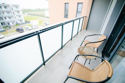 two chairs and a table on a balcony at Cristian Point Apartment With Parking in Cristian