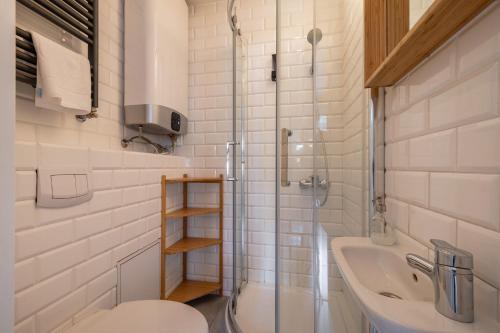 a bathroom with a sink and a toilet and a tub at RentPlanet - Studio Rynek Ratusz in Wrocław