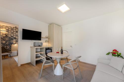 a living room with a table and a couch at Hotel Baia Imperiale in Campo nell'Elba