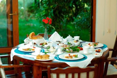 a table with plates of food on it at Günebakan Taliani Otel in Ayvalık