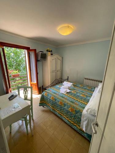 a bedroom with a bed and a table and a window at Casa Bicocchi in Lanciole