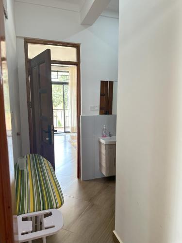 a room with a door to a kitchen with a mirror at Zaya Residency in Kampala