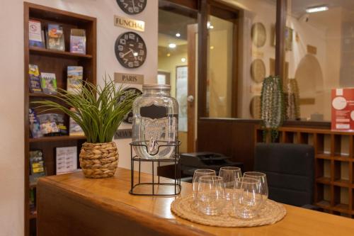 a table with wine glasses and a bottle on it at Flag Hotel Madeira - Ribeira Brava in Ribeira Brava