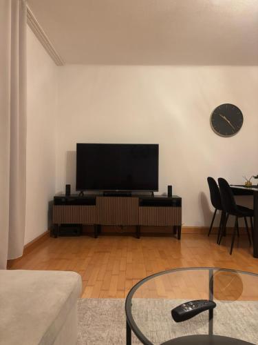 a living room with a flat screen tv on a wall at Cozy 2-Bedroom Retreat Near Subway and City Center in Vienna
