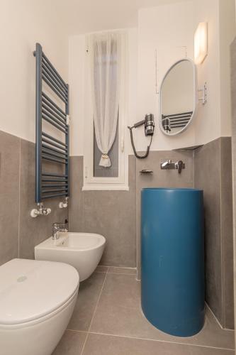 a bathroom with a toilet and a sink and a mirror at Suit Dante in Genoa