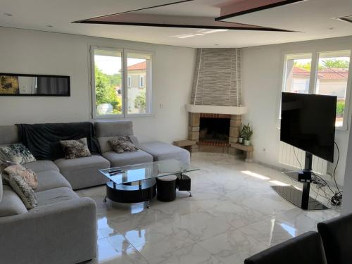 Il comprend un salon doté d'un canapé, d'une télévision et d'une cheminée. dans l'établissement Maison spacieuse très calme, Albi centre, à Albi