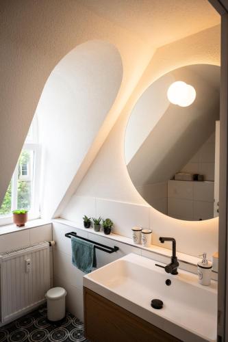 a bathroom with a sink and a mirror at Altstadt Auszeit in Freiburg im Breisgau