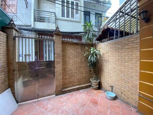 un bâtiment avec un portail et un mur en briques dans l'établissement DA Travel Home - Hanoi Hostel, à Hanoï