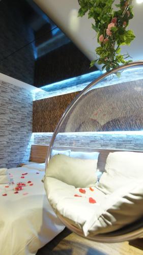 a bed with flowers on it in a room at Colors Infinity Inn in Taipei
