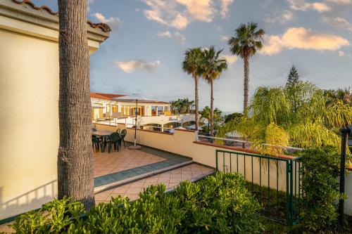 a balcony of a house with palm trees at Residence Antigua in Bonifati