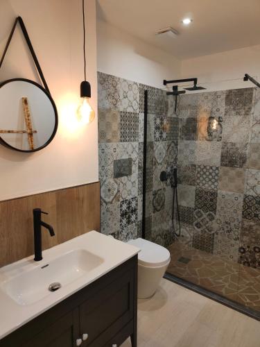 a bathroom with a sink and a toilet and a shower at Suite12 in Marsala