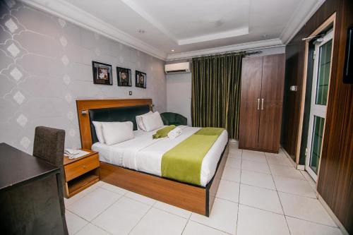 a hotel room with a bed and a desk and a desk at Elegance Suites Hotels in Lagos