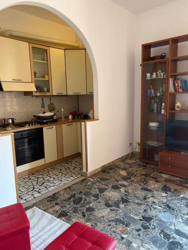 a kitchen with an archway in the middle of a room at Via degli Dei house in Sasso Marconi