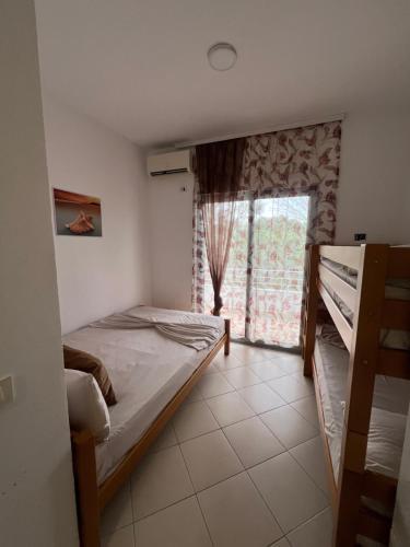 a bedroom with two bunk beds and a window at Hotel PEJA in Velipojë