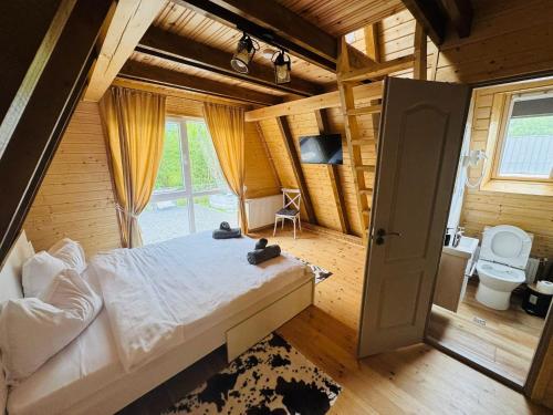a bedroom with a bed in a wooden house at Cabana Twins A-Frame 2 in Sibiu