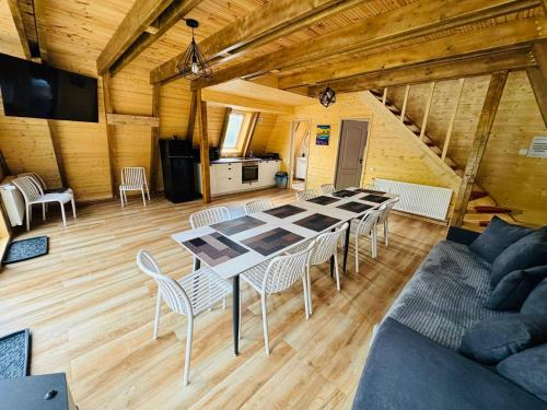 a large dining room with a table and chairs at Cabana Twins A-Frame 2 in Sibiu
