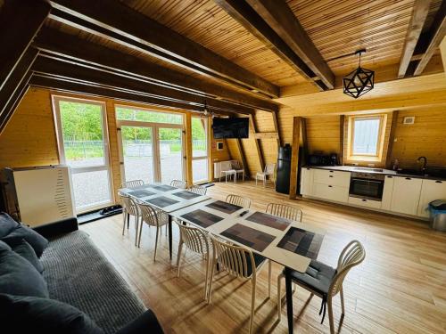 a dining room with a table and chairs in a room at Cabana Twins A-Frame 2 in Sibiu