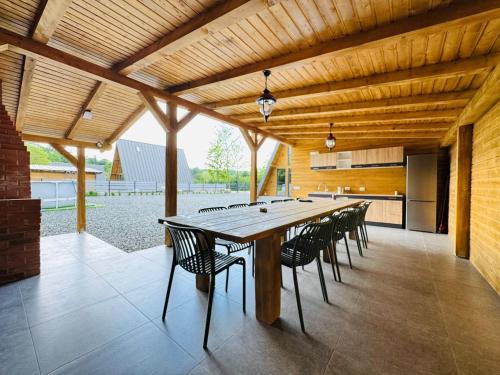 a large dining room with a long table and chairs at Cabana Twins A-Frame 2 in Sibiu