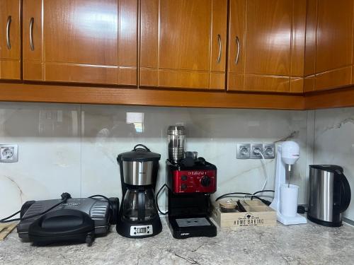 a kitchen counter with a blender and other appliances at Angel's Heaven in Sikia