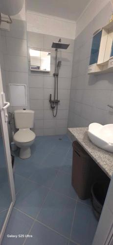 a bathroom with a toilet and a sink at Divine place Pomorie in Pomorie