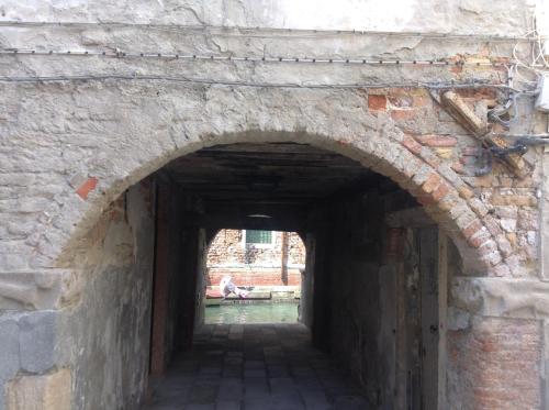 an alley in a brick wall with an archway at Ca dei Libri in Venice