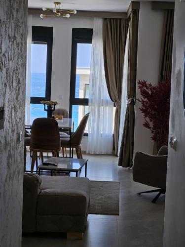 a living room with a couch and a table and chairs at Vienna Luxury Apartments in Dobra Voda