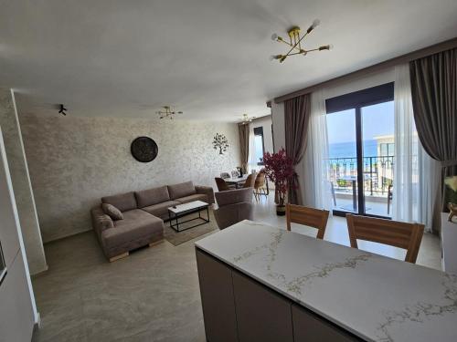 a living room with a couch and a table at Vienna Luxury Apartments in Dobra Voda
