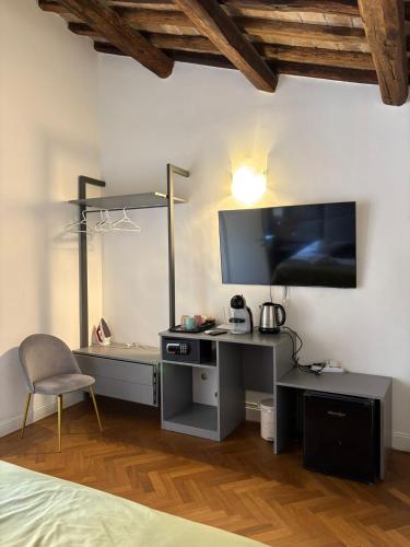 a bedroom with a desk with a tv and a chair at Ah Suite Trevi in Rome