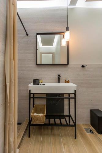 a bathroom with a sink and a mirror at Aegean View in Metamorfosi