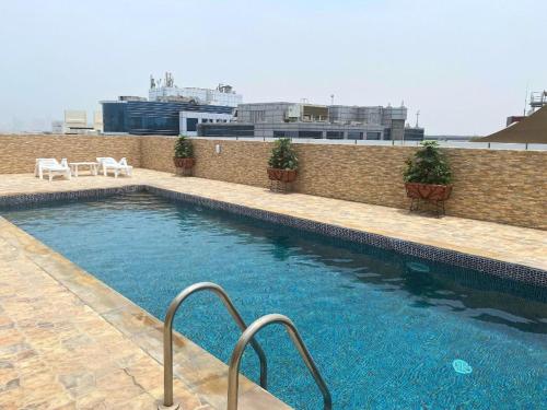 a swimming pool on the side of a building at Studio Apartment Near Deira City Centre Mall and Metro with Gym and Pool in Dubai