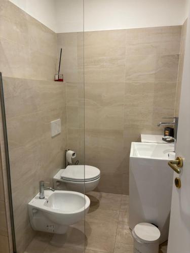 a bathroom with a toilet and a sink at Ah Suite Trevi in Rome