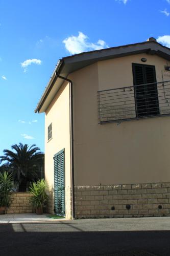 a white building with a gate and a palm tree at TataBlu residenza con parcheggio in Florence