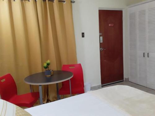 Voodi või voodid majutusasutuse Reste En Jaunte inside The Cattleya Hotel toas