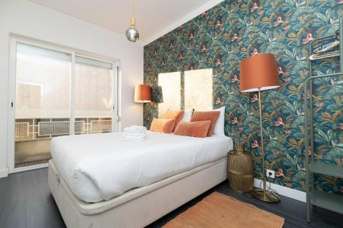 a bedroom with a large bed with a floral wallpaper at Lisbon Hideaway near the River in Lisbon