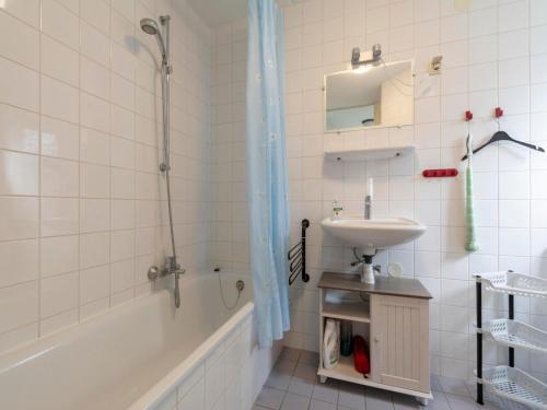 a bathroom with a shower and a sink and a tub at Villa in Julianadorp near Sandy Beach in Julianadorp