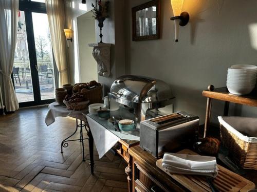 a kitchen with a counter with a toaster oven on it at Gutshaus Redewisch Hotel & Restaurant in Boltenhagen