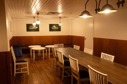 a dining room with a table and chairs at Hotel Adlon in Mariehamn