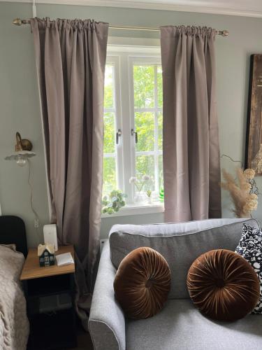 a living room with a couch and a window at Trhastbb in Herräng