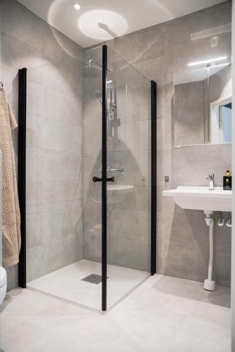 a bathroom with a shower and a sink at Mörrum River Residences in Mörrum